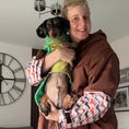 Load image into Gallery viewer, Person wearing the DoxieBurrow waterproof dog walking robe coat while carrying a dachshund.