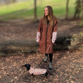 Load image into Gallery viewer, Woman wearing the DoxieBurrow waterproof dog walking robe coat with a dachshund wearing a matching coat outdoors.