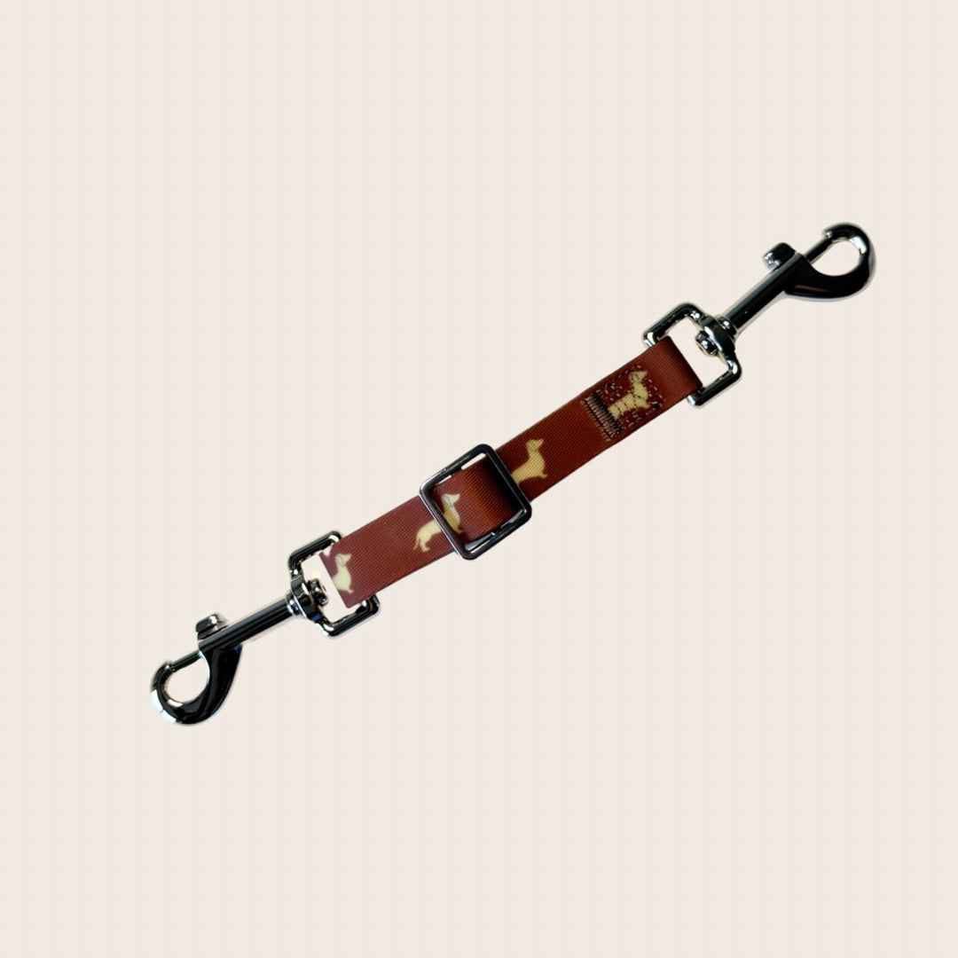 DoxieFlex Biothane dachshund dog safety clip connecting a collar and harness for extra security on walks.