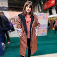 Load image into Gallery viewer, Woman wearing the DoxieBurrow waterproof dog walking robe coat at an outdoor event.
