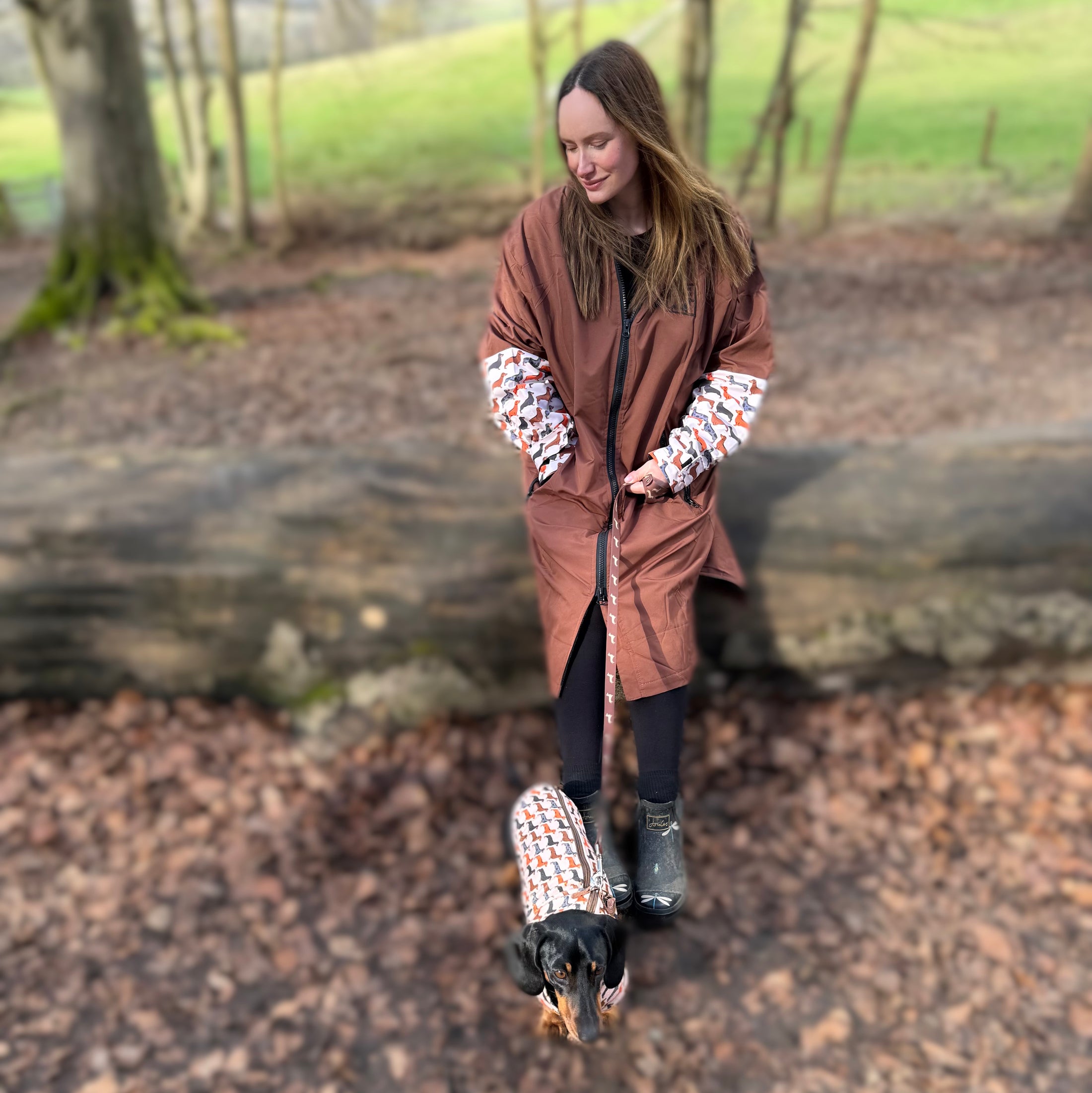 DoxieBurrow waterproof dog walking robe coat worn during a countryside walk.