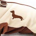 Load image into Gallery viewer, Close up of cream DoxieDri water resistant fleece with brown Dachshund embroidery
